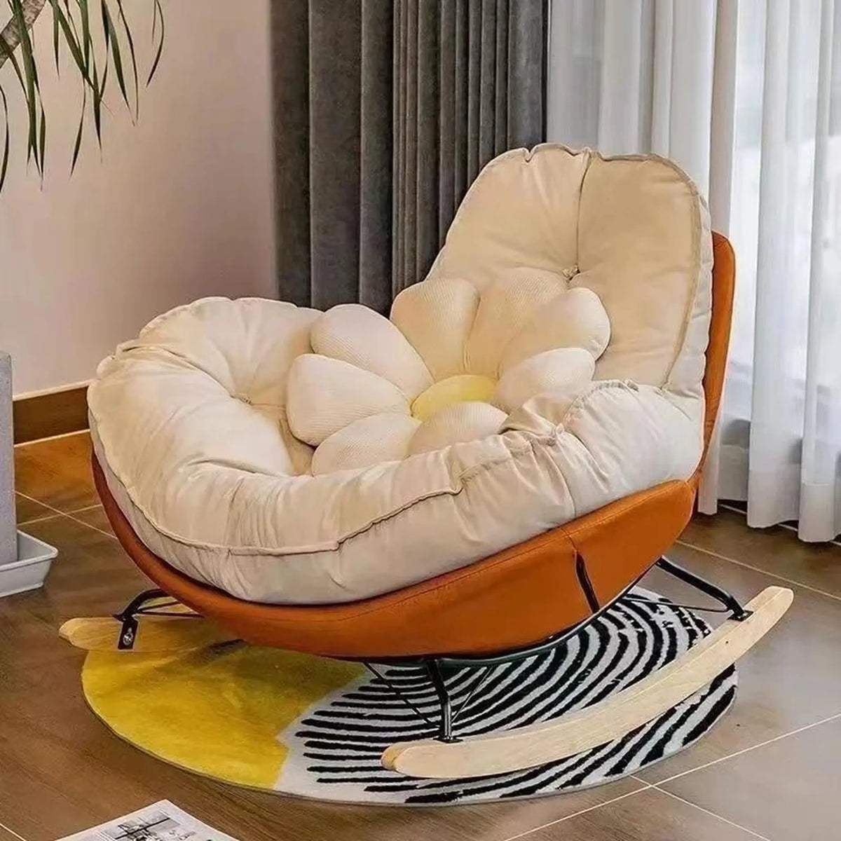 Fauteuil à bascule coque orange et coussin crème