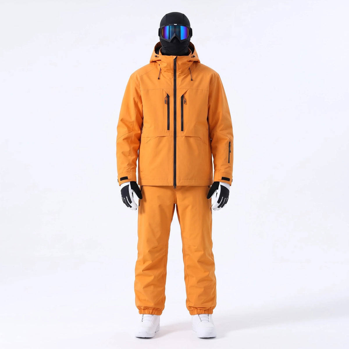 Pack Tignes – combinaison de ski orange portée avec gants, masque et cagoule